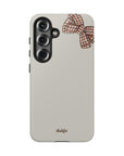 Phone case with a checkered bow design on a white background