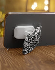 Muse Phone Grip featuring black floral designs on white background in glossy or matte finish