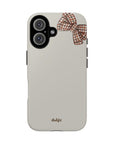 Phone case with a bow design and 'dalge' branding on a beige background