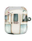 Pick Me Up At 8 Earbuds Case—Glossy polycarbonate shell featuring vintage travel watercolor camper and floral artwork, lightweight design, with clip attachment.