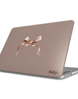 MacBook case from the Toffee Latte Fall Collection showcasing a warm brown background and a delicate salmon pink bow for a chic and sophisticated look.