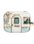 Pick Me Up At 8 Earbuds Case—Glossy polycarbonate shell featuring vintage travel watercolor camper and floral artwork, lightweight design, with clip attachment.
