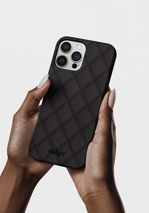 A person holding an iPhone with a Black Geometric matte phone case, featuring the brand name 'dalge' at the bottom, against a plain light background