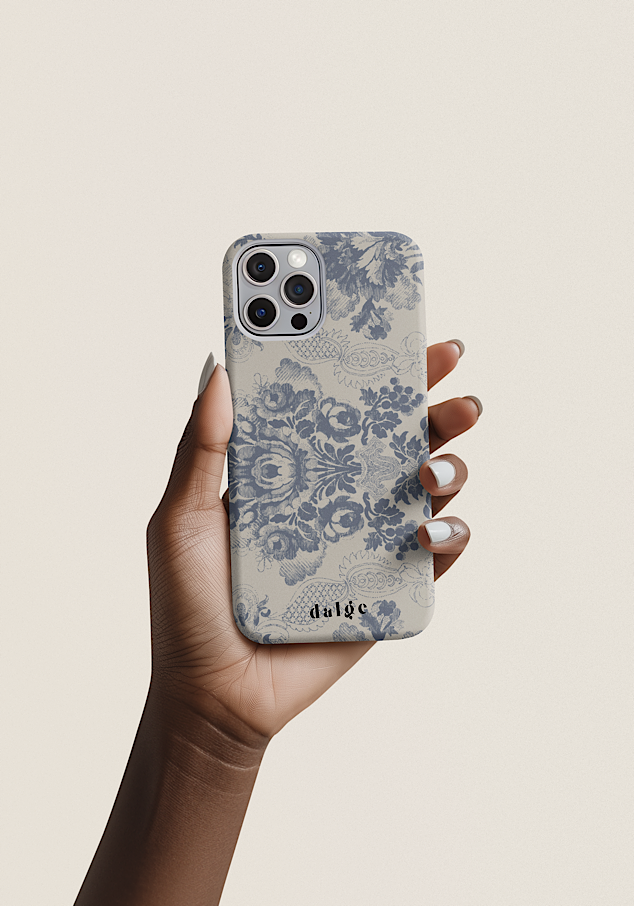 A person holding an iPhone with a Shabby Chic phone case, featuring the brand name 'dalge' at the bottom, against a plain light background