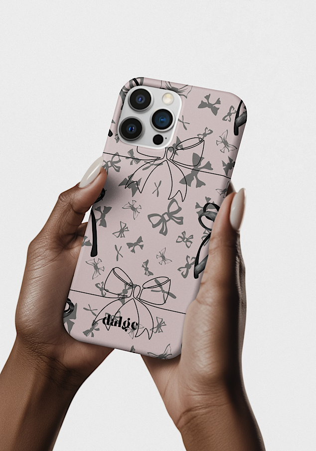 A person holding an iPhone with a pink floral and bow-themed phone case, featuring the brand name 'dalge', against a plain light background