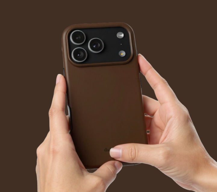 Brown phone case held by hands against a brown background