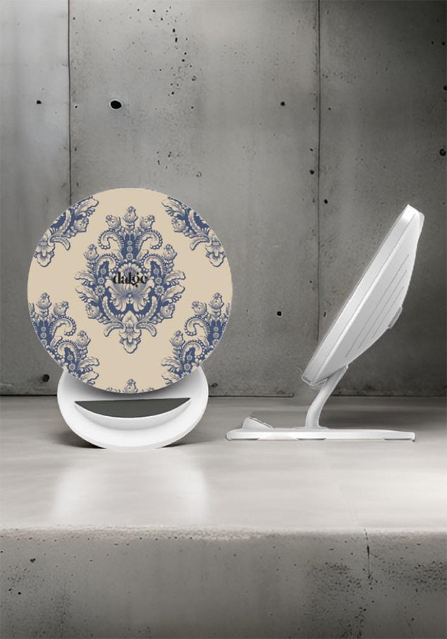 Close up of wireless charger with shabby chic blue and beige designs with a brand name dalge  printed at the front on a grey industrial background